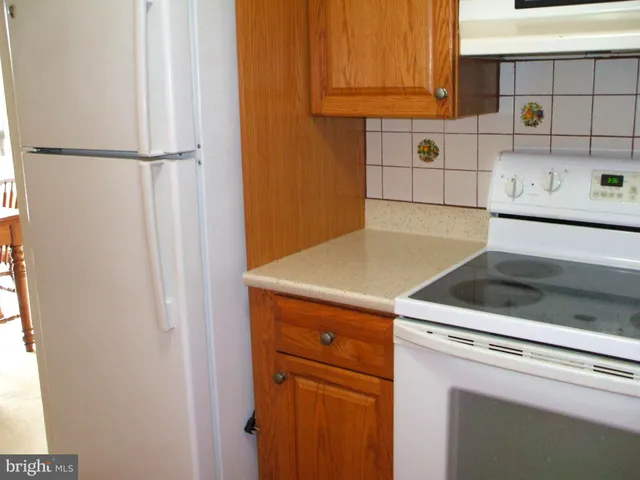 a view of a kitchen with refrigerator and cabinet