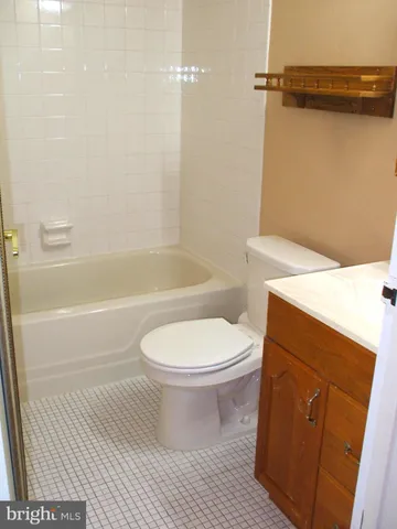 a bathroom with a toilet and a bath tub