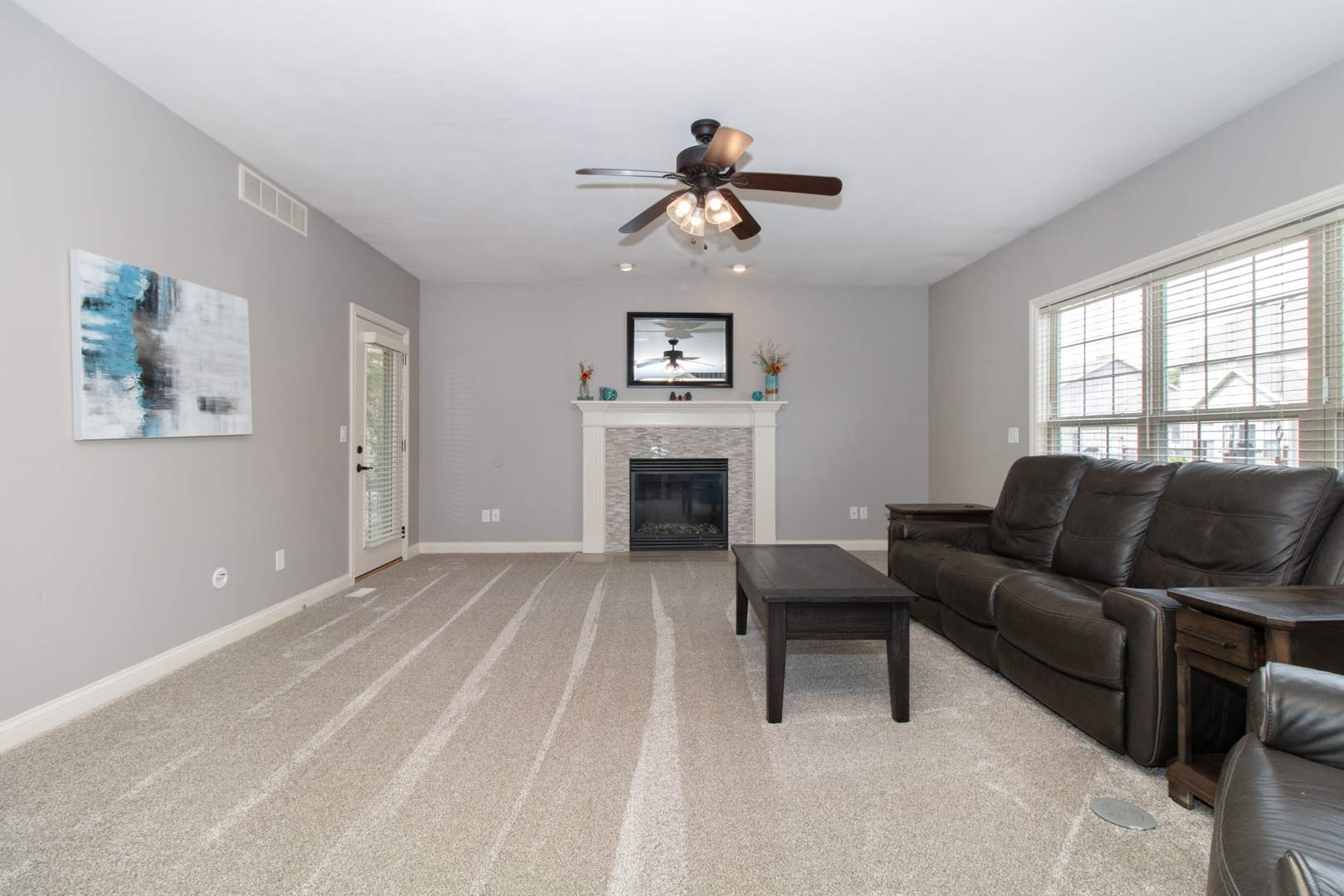 4002 Rockledge Road Bloomington, IL 61705 - Photo 13 of 60 a living room with furniture a fireplace and a window