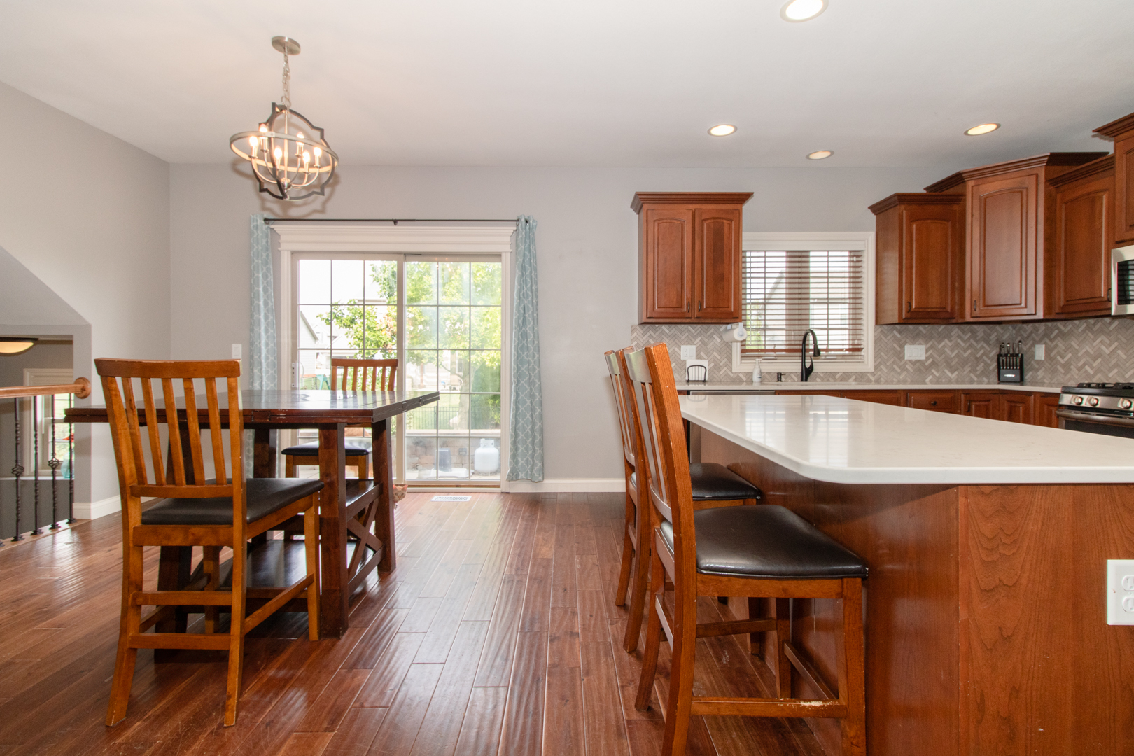 4002 Rockledge Road Bloomington, IL 61705 - Photo 20 of 60 a dining room with furniture a chandelier and wooden floor