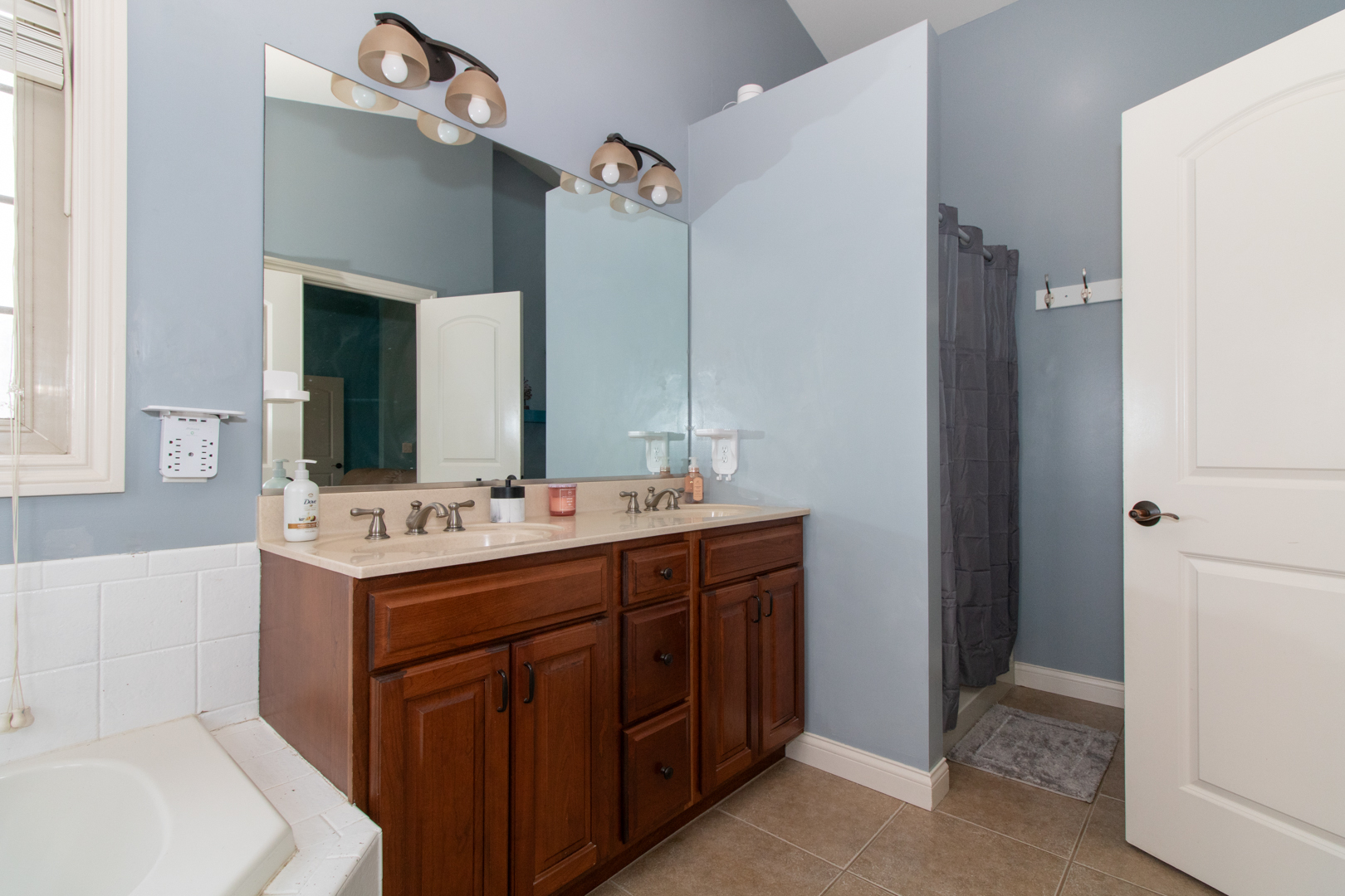 4002 Rockledge Road Bloomington, IL 61705 - Photo 37 of 60 a bathroom with a double vanity sink and mirror