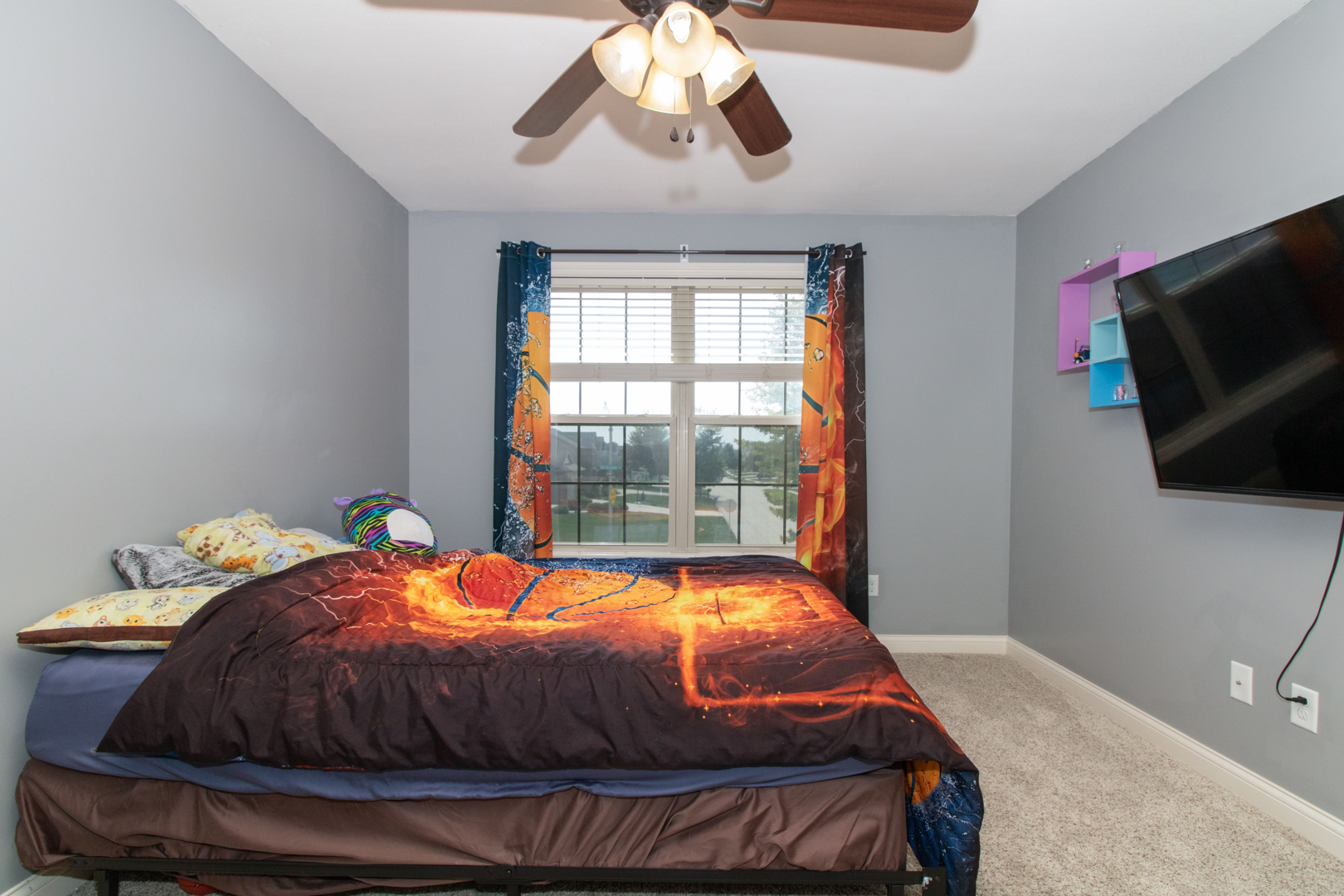 4002 Rockledge Road Bloomington, IL 61705 - Photo 42 of 60 a bedroom with a bed and flat screen tv