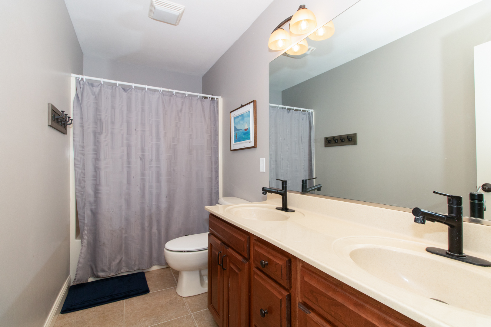 4002 Rockledge Road Bloomington, IL 61705 - Photo 47 of 60 a bathroom with a sink a toilet and a large mirror