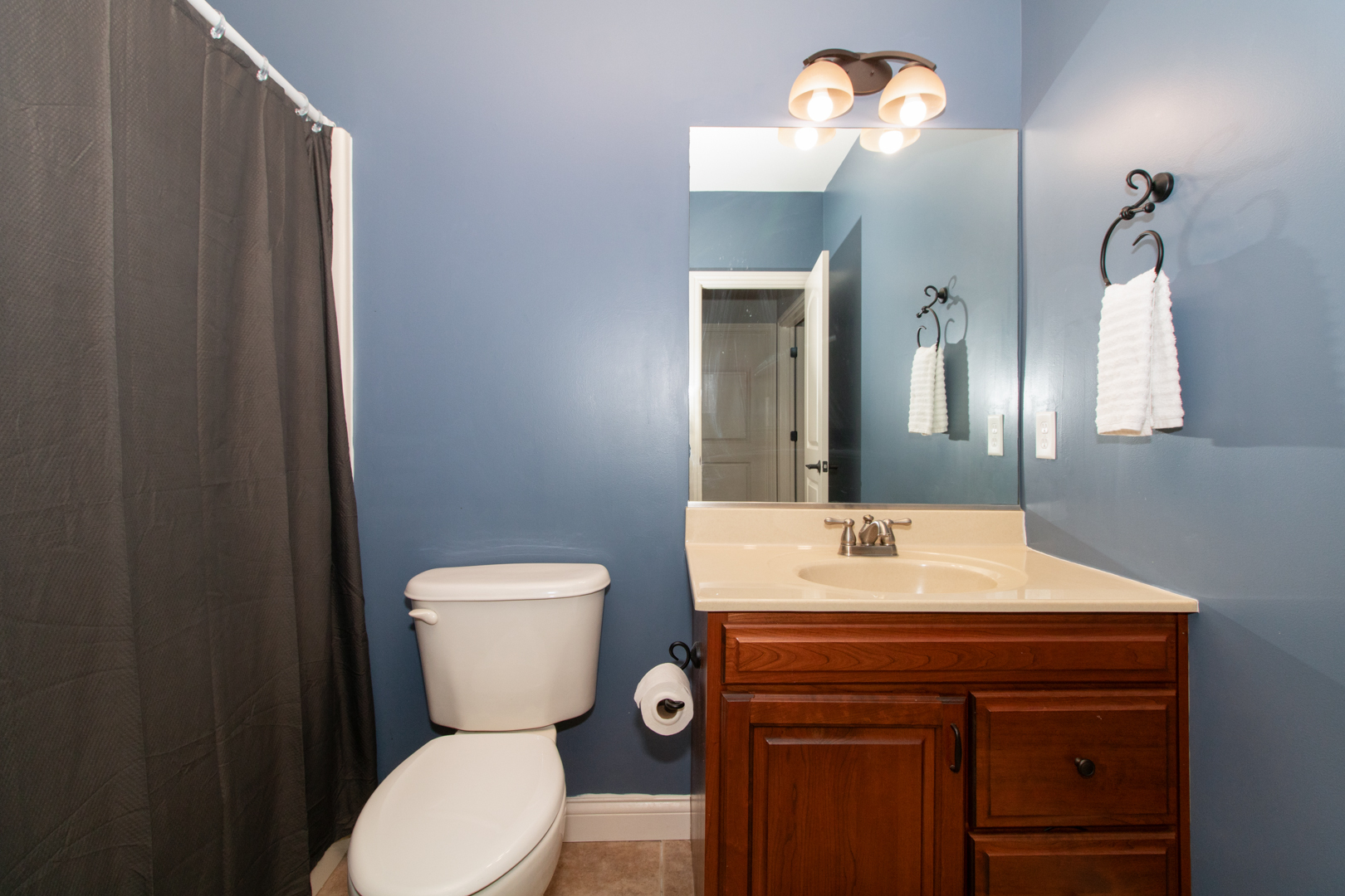 4002 Rockledge Road Bloomington, IL 61705 - Photo 55 of 60 a bathroom with a toilet a sink and mirror