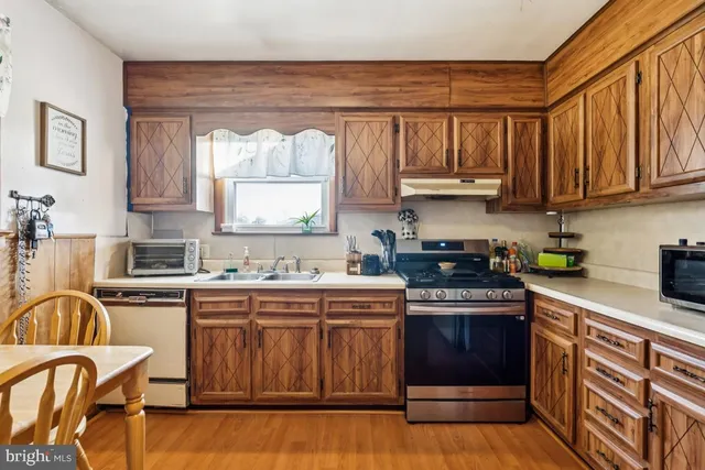 a kitchen with stainless steel appliances granite countertop a stove cabinets and a refrigerator