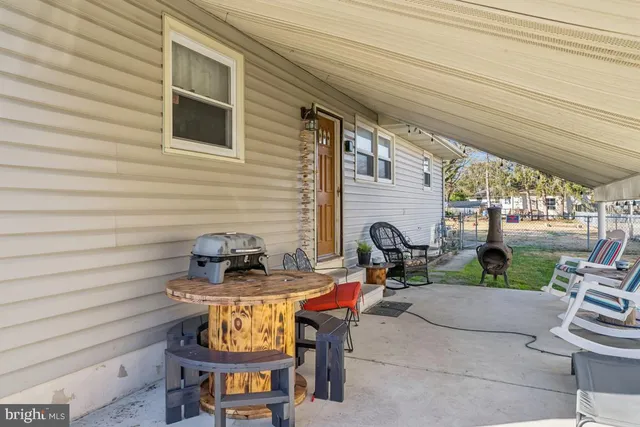 a view of a backyard with plants and patio