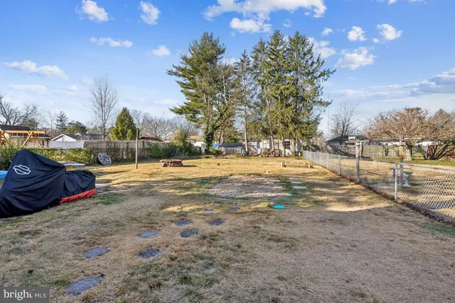a swimming pool with trees in the background