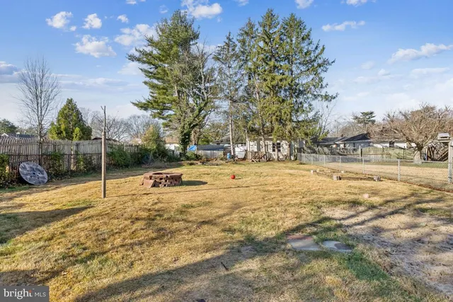 a swimming pool with outdoor seating and yard