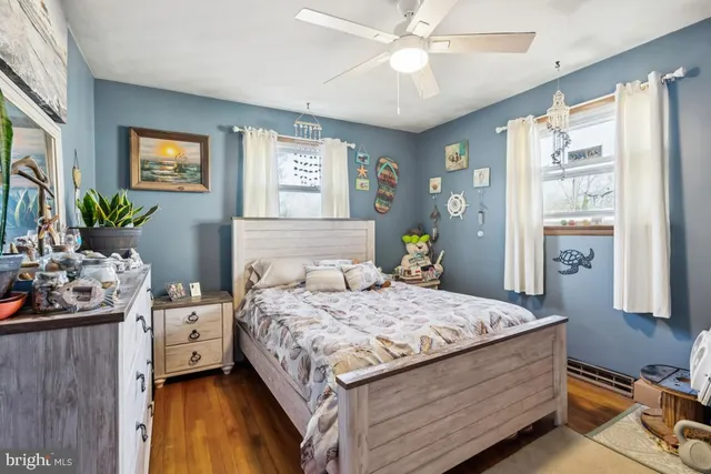 a bedroom with a bed and a mirror on dresser
