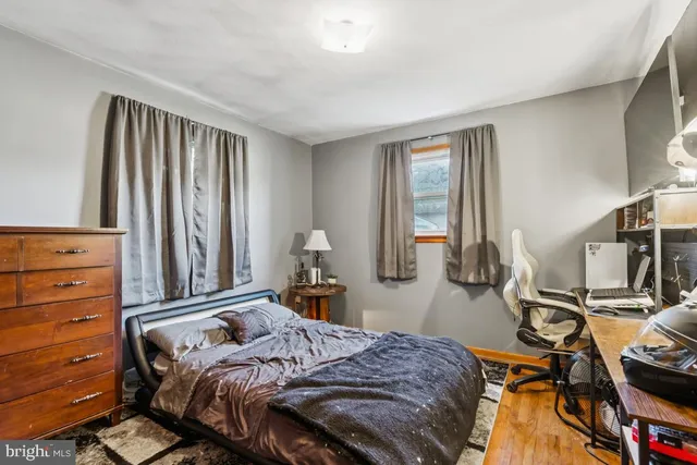 a living room with furniture a flat screen tv and a window
