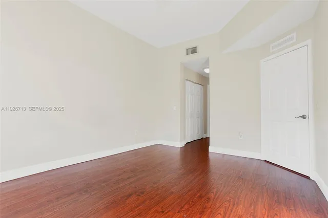 an empty room with wooden floor