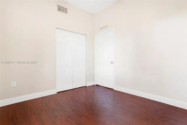 an empty room with wooden floor