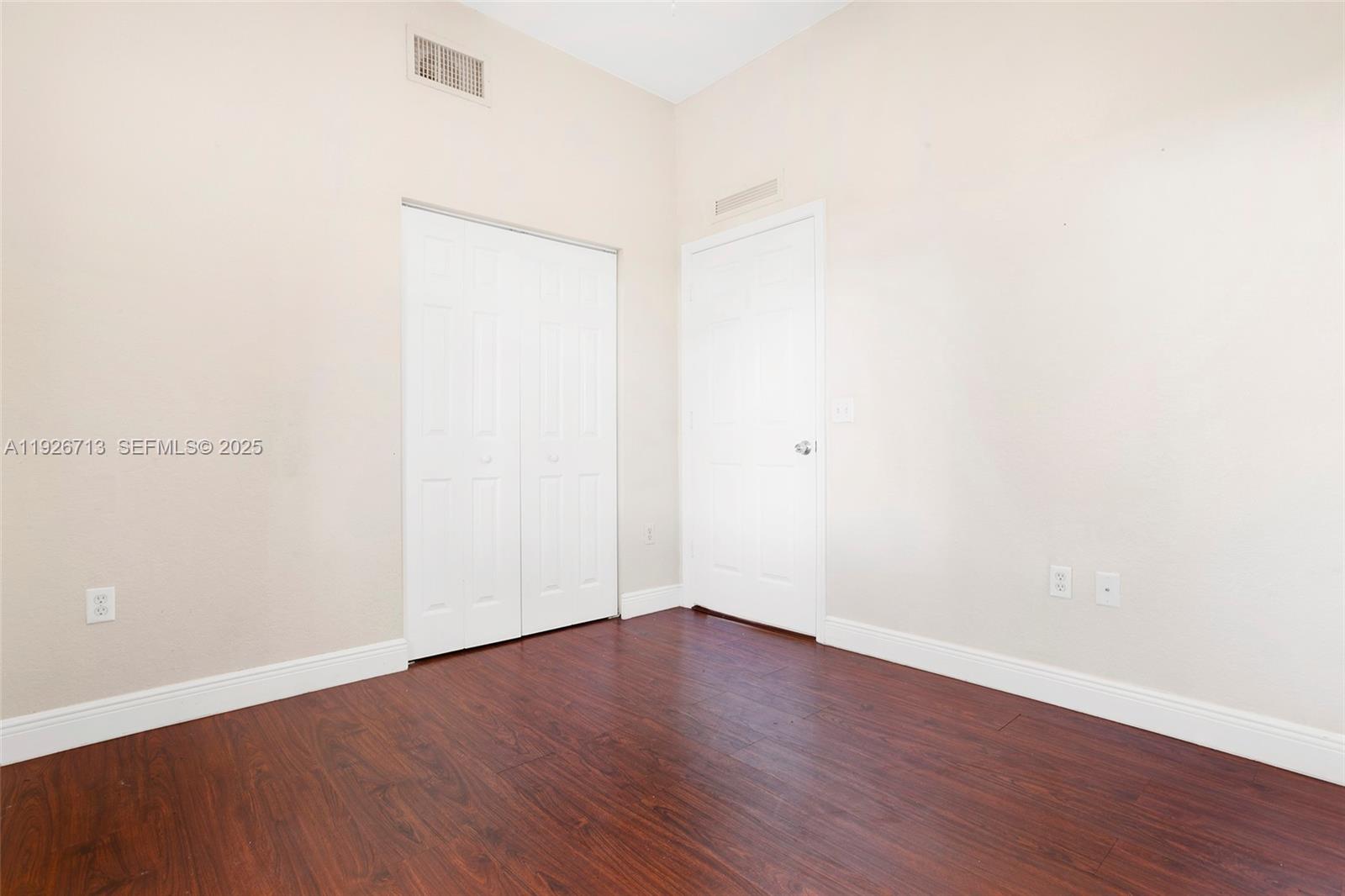 3340 Palomino Drive, Unit 2112 Davie, FL 33024 - Photo 16 of 25 an empty room with wooden floor