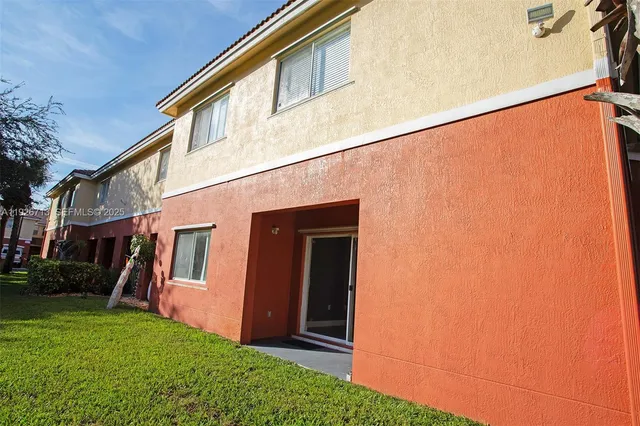 a view of house with backyard and garden