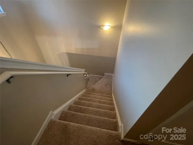 a view of a hallway with closet and mirror
