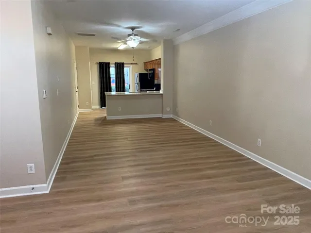 a view of kitchen with refrigerator and cabinets