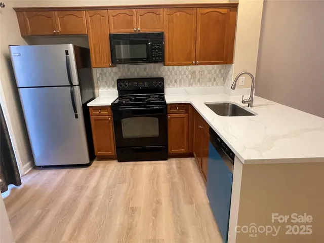 a kitchen with a refrigerator and a microwave