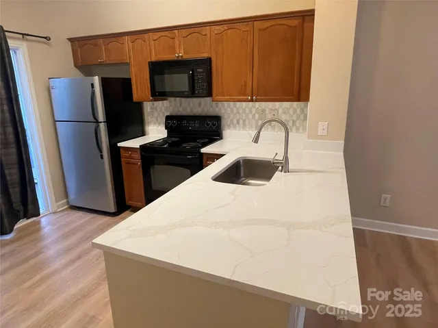a kitchen with a refrigerator and a stove