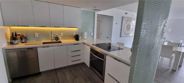 a kitchen with a sink and cabinets