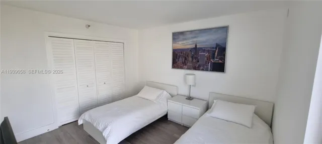 a bedroom with a bed and a wall painting