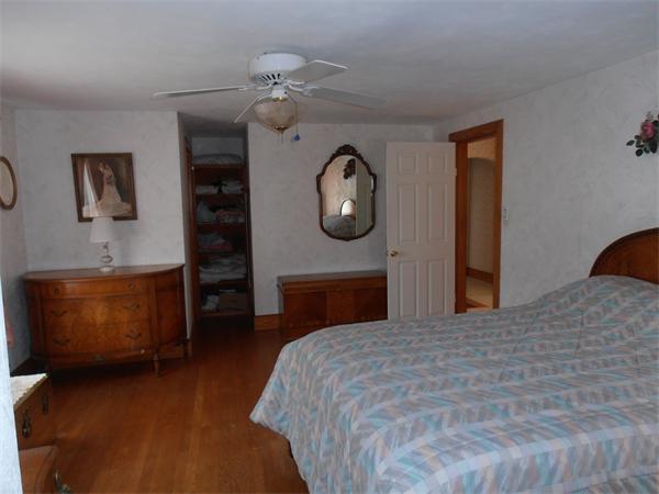 54 Denver Street Springfield, MA 01109 - Photo 11 of 30 a bedroom with a bed and a chandelier