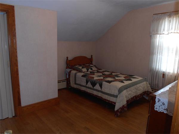 54 Denver Street Springfield, MA 01109 - Photo 14 of 30 a bedroom with a bed and window