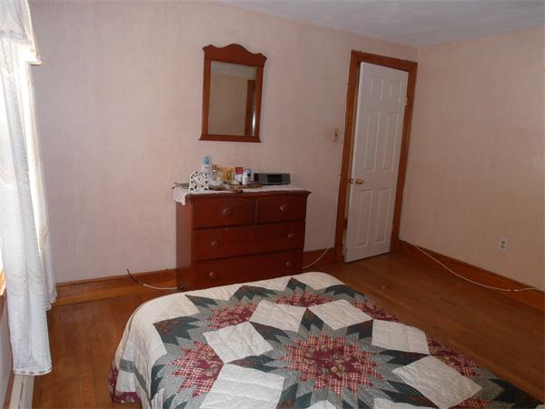 54 Denver Street Springfield, MA 01109 - Photo 15 of 30 a bedroom with a bed and a dresser