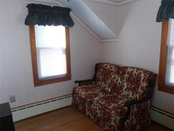 54 Denver Street Springfield, MA 01109 - Photo 18 of 30 a bed sitting in a bedroom next to a window