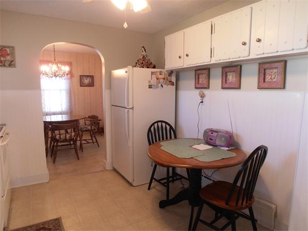 54 Denver Street Springfield, MA 01109 - Photo 7 of 30 a kitchen with stainless steel appliances granite countertop a dining table chairs and a refrigerator