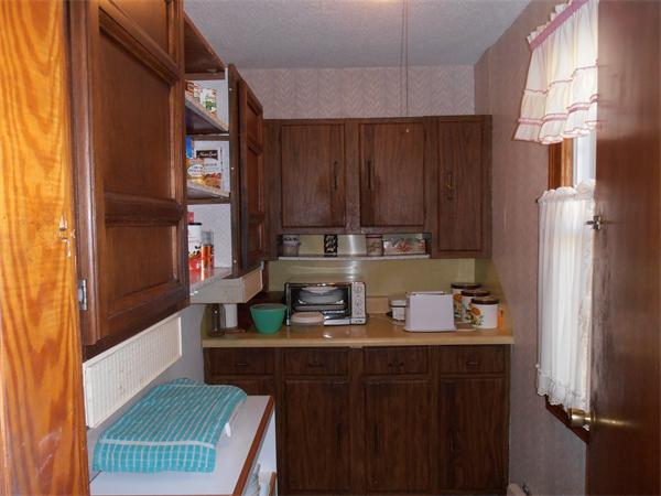 54 Denver Street Springfield, MA 01109 - Photo 9 of 30 a kitchen with a refrigerator and a stove