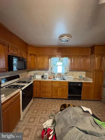 a kitchen with a stove a refrigerator and a sink