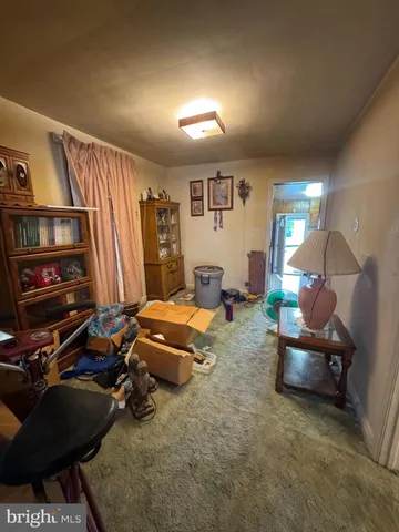a living room with furniture and a dresser