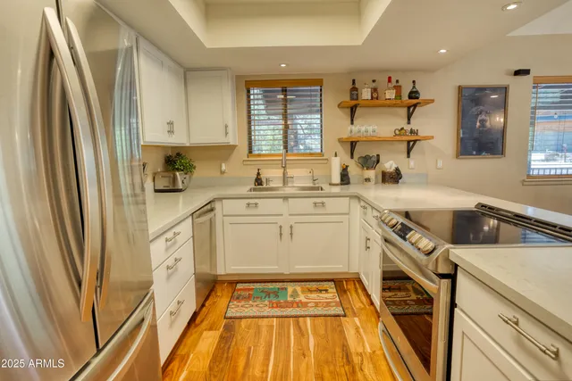 a view of a kitchen with a sink a refrigerator and window