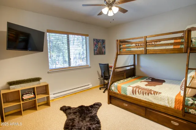 a bed sitting in a bedroom next to a window