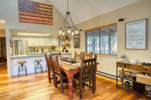 a view of a dining room with furniture and chandelier