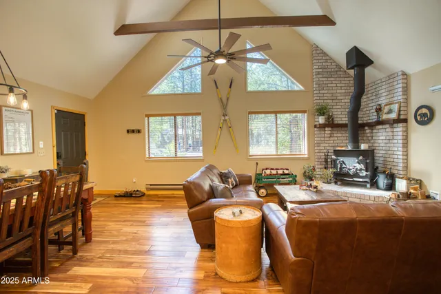 a living room with fireplace furniture and a chandelier