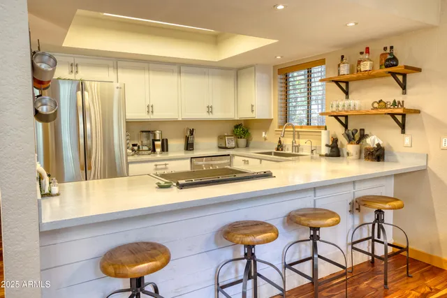 a kitchen with a sink and a refrigerator