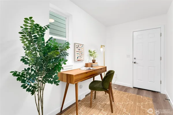 a view of a workspace with furniture and a potted plant