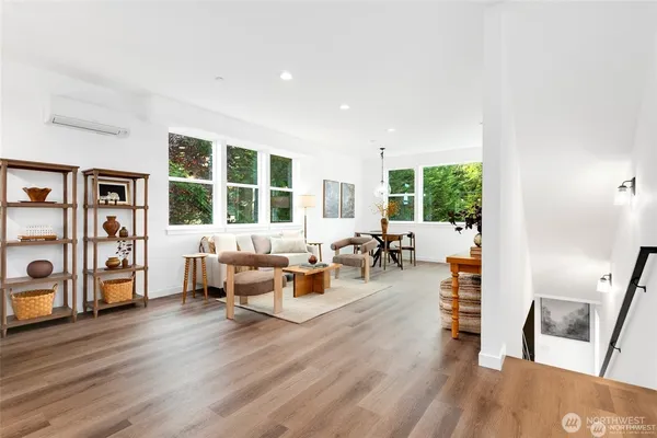 a living room with furniture and wooden floor