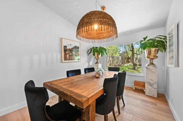 a kitchen with granite countertop a stove a sink a center island and cabinets