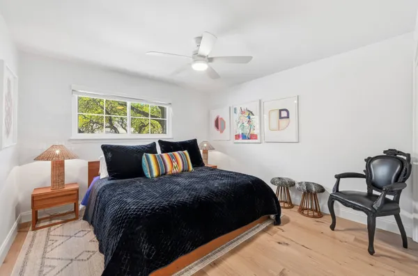 a bathroom with a granite countertop sink a toilet and a shower