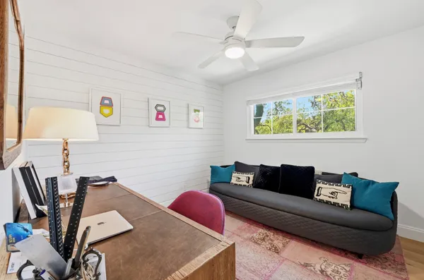 a outdoor living space with furniture a fireplace and a flat screen tv