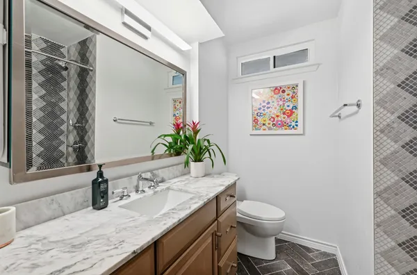 a living room with patio furniture and a garden