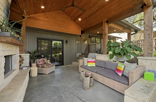 a view of backyard with a table and chair under an umbrella