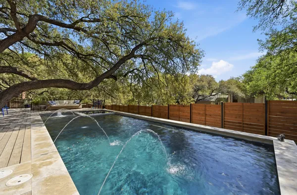 a view of a yard with table and chairs under an umbrella
