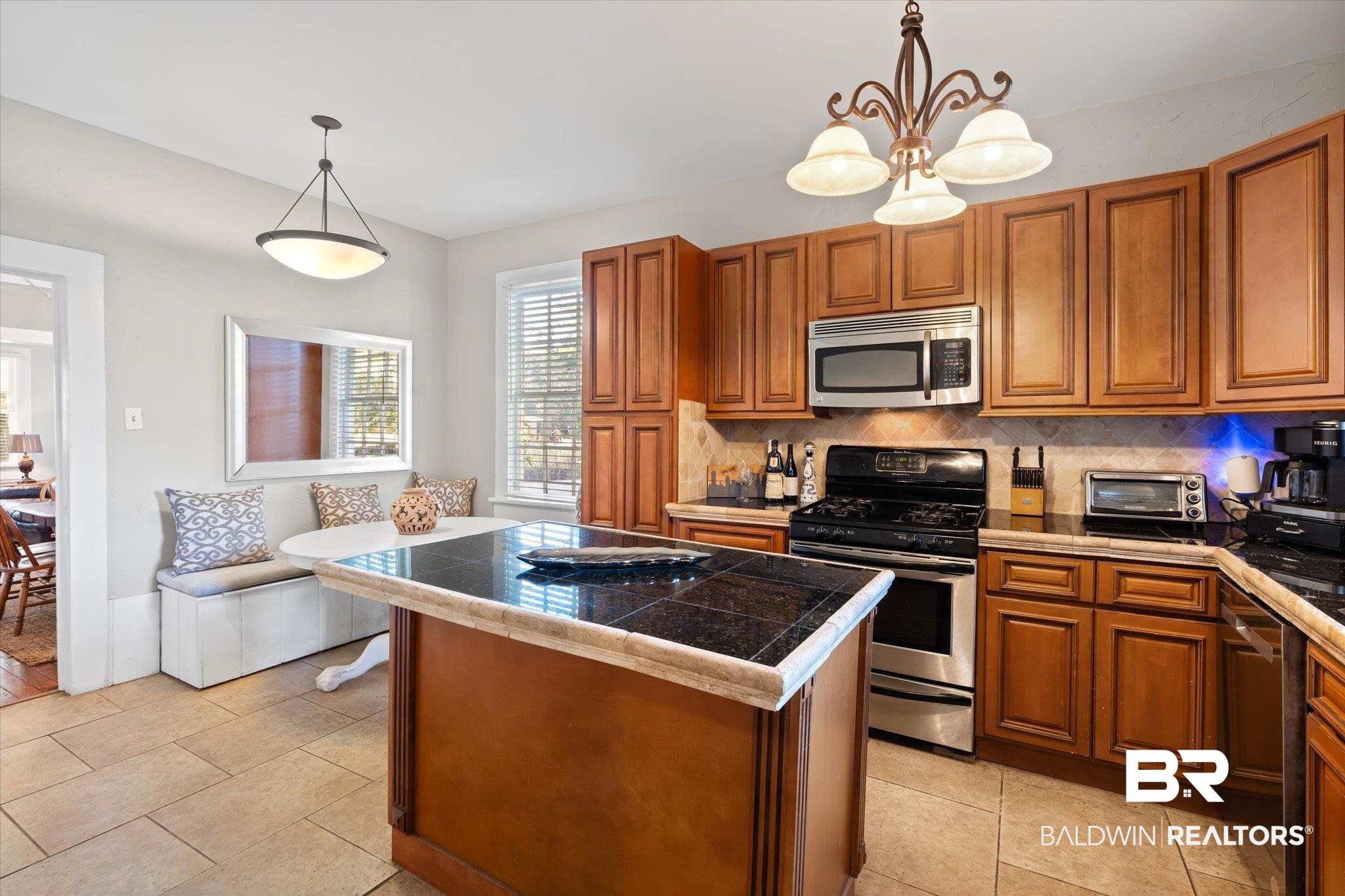 7 Rickarby Place Mobile, AL 36606 - Photo 8 of 20 Kitchen with decorative backsplash, a kitchen island, decorative light fixtures, and appliances with stainless steel finishes