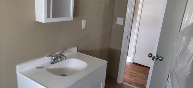 a bathroom with a sink and mirror