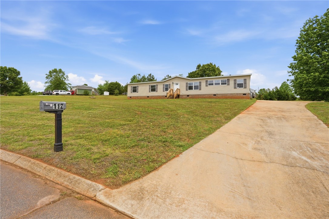 112 Sir Francis Drake Way Liberty, SC 29657 - Photo 6 of 42 A charming residence with a spacious lawn and a welcoming front entrance.