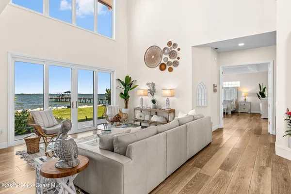 a kitchen with stainless steel appliances a sink dishwasher stove and white cabinets with wooden floor