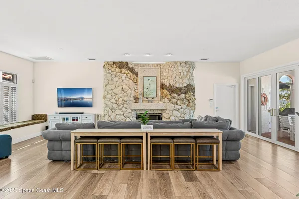 a view of a house with wooden fence next to a yard